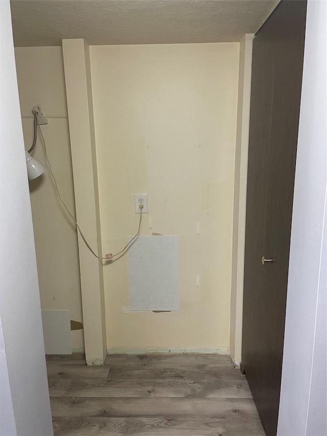 laundry room with hardwood / wood-style floors