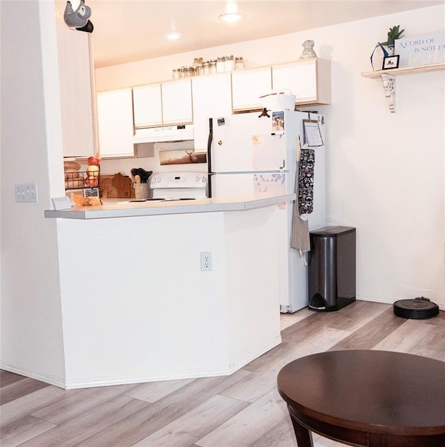 kitchen featuring range, white fridge, white cabinetry, and light hardwood / wood-style flooring