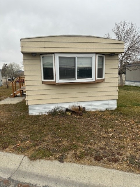 view of side of home featuring a yard