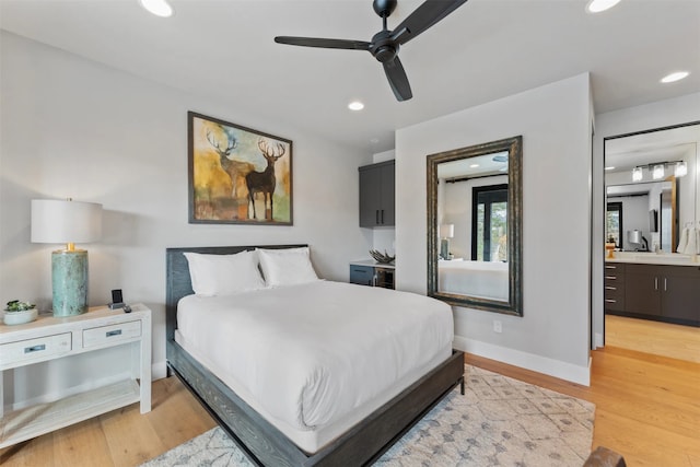1148 Glades Dr, Whitefish, MT 59937 - bedroom featuring ceiling fan, light wood-type flooring, sink, and connected bathroom