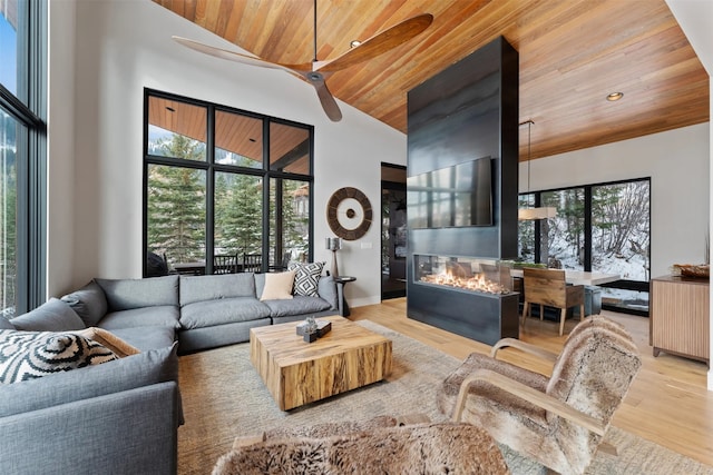 1148 Glades Dr, Whitefish, MT 59937 - living room featuring ceiling fan, high vaulted ceiling, wood ceiling, and light wood-type flooring