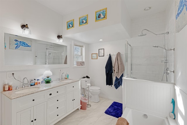 bathroom with vanity, a shower with shower door, and toilet