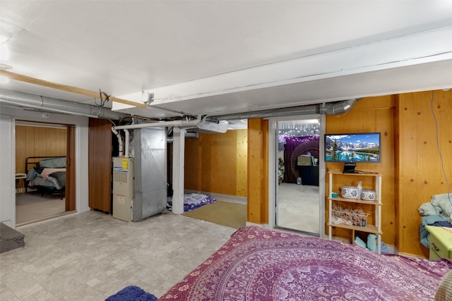 basement with heating unit and wooden walls