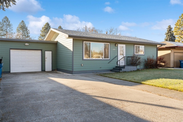 ranch-style house with a garage and a front lawn