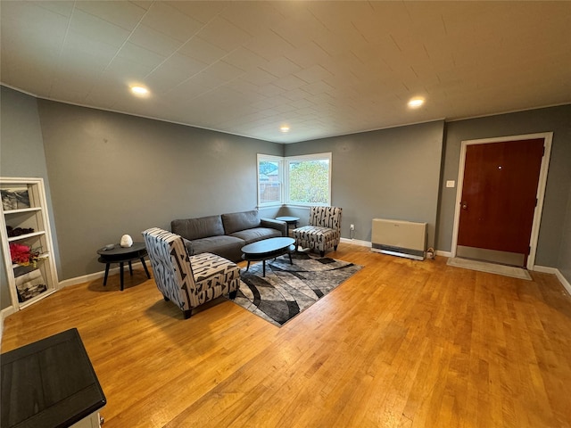 living room with light wood-type flooring and heating unit