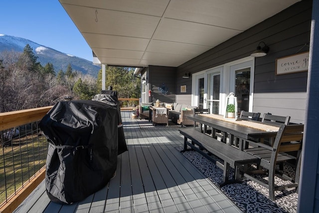 deck with a mountain view and grilling area