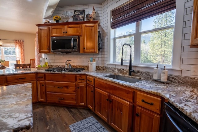 kitchen featuring plenty of natural light, sink, appliances with stainless steel finishes, and dark wood-type flooring