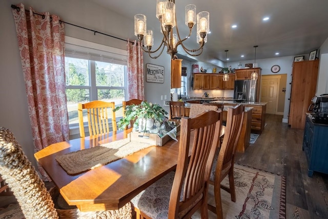 dining room featuring an inviting chandelier, dark wood-type flooring, and sink