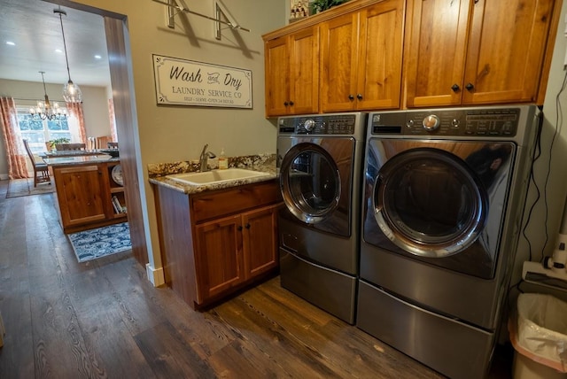 laundry room featuring cabinets, dark wood-type flooring, sink, and a chandelier