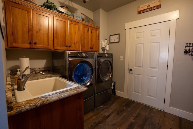 laundry room featuring dark hardwood / wood-style floors, cabinets, separate washer and dryer, and sink