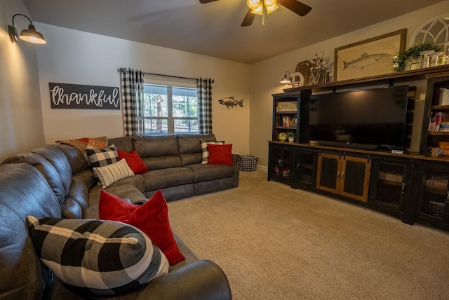 carpeted living room with ceiling fan