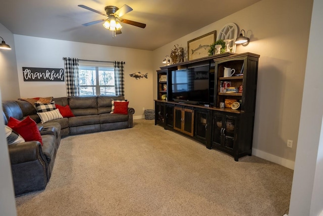 carpeted living room with ceiling fan