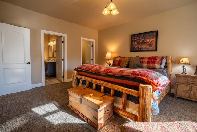 carpeted bedroom with a chandelier and ensuite bathroom