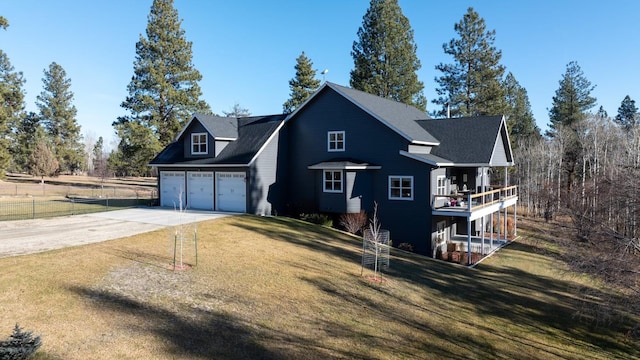 view of front of home featuring a balcony, a front lawn, and a garage