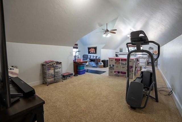 workout area featuring carpet, ceiling fan, plenty of natural light, and vaulted ceiling