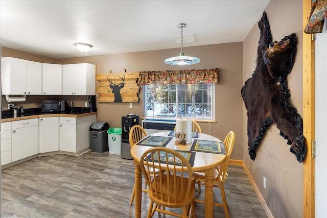 dining space with hardwood / wood-style floors