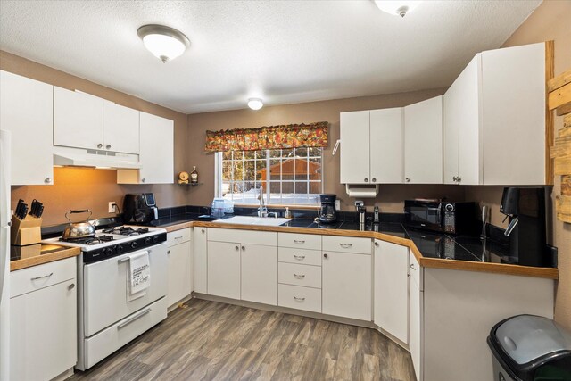 kitchen with white range, a textured ceiling, sink, wood-type flooring, and white cabinets