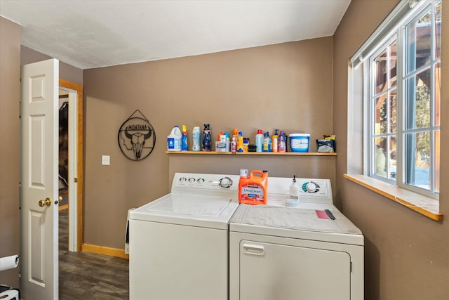 clothes washing area with washer and dryer, dark hardwood / wood-style floors, and a wealth of natural light