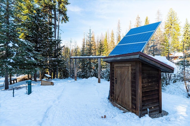 snow covered structure with solar panels