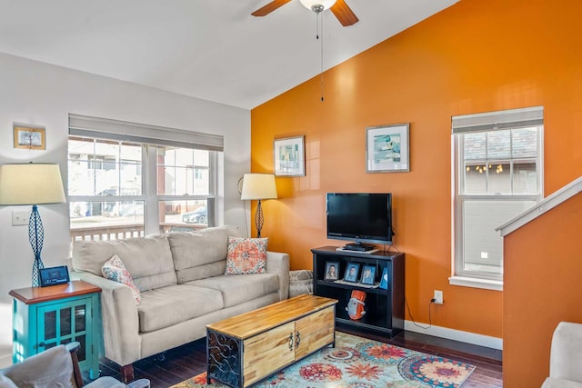 living room with ceiling fan, a healthy amount of sunlight, dark hardwood / wood-style flooring, and vaulted ceiling