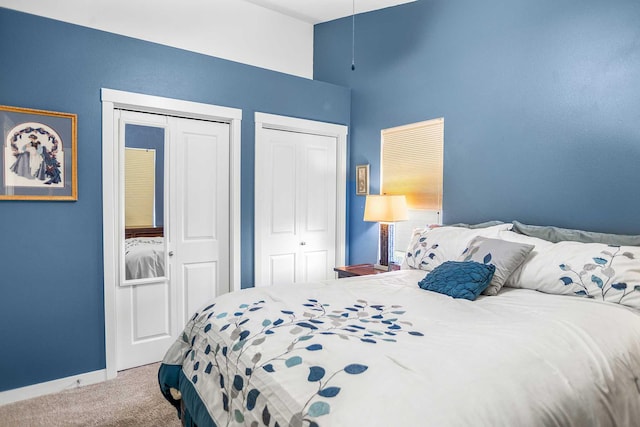 carpeted bedroom with two closets