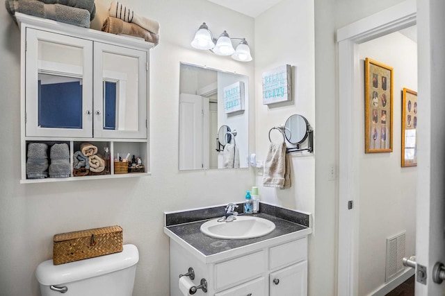 bathroom featuring vanity and toilet