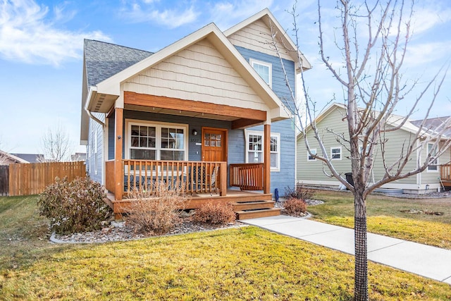 view of front of home with covered porch and a front yard