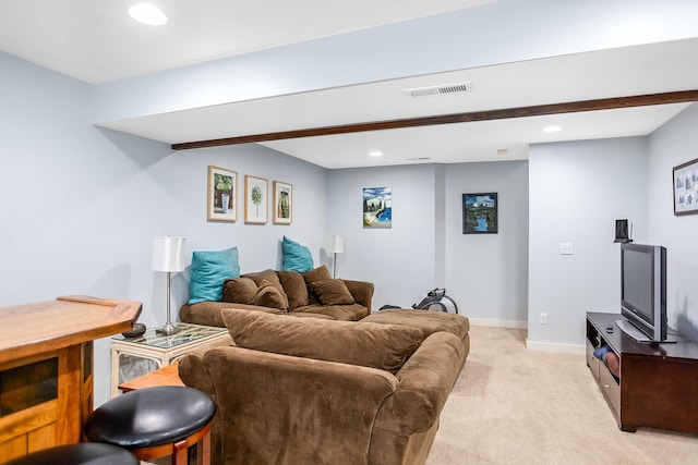 carpeted living room with beamed ceiling