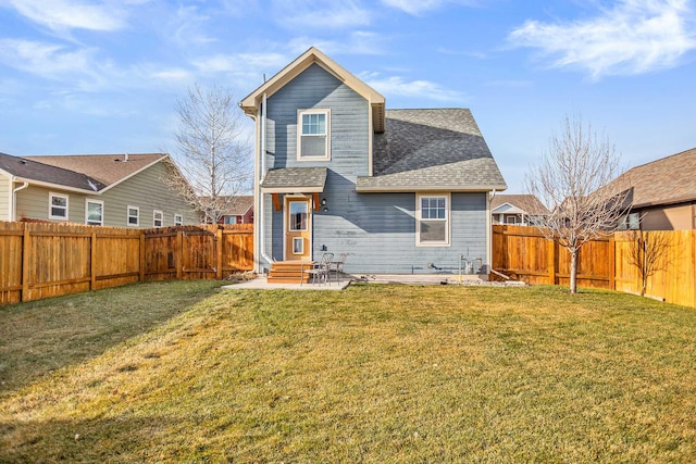 rear view of property with a lawn and a patio