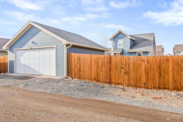 exterior space featuring a garage and an outbuilding