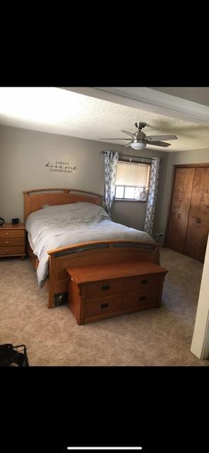 bedroom featuring ceiling fan and light carpet