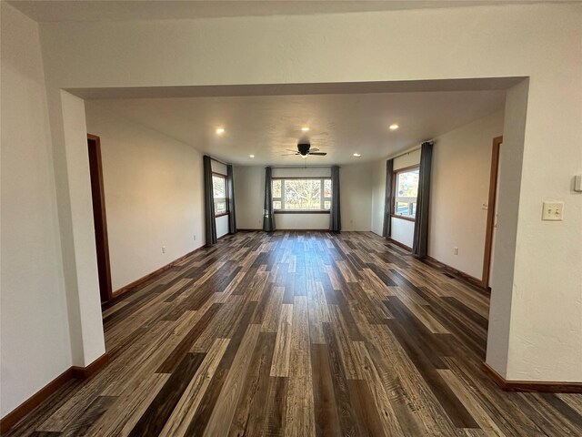 unfurnished living room featuring dark hardwood / wood-style floors and ceiling fan