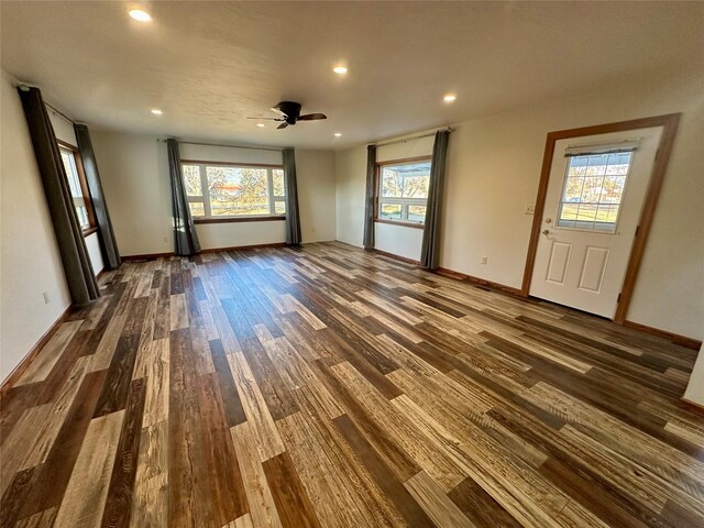 unfurnished room with ceiling fan, dark hardwood / wood-style flooring, and a wealth of natural light