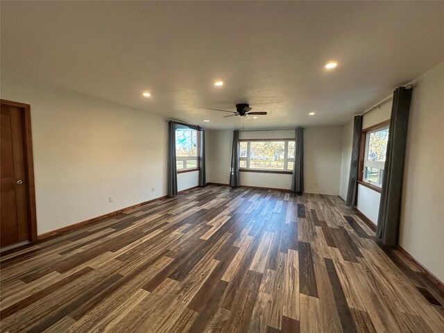 empty room with dark hardwood / wood-style floors and ceiling fan