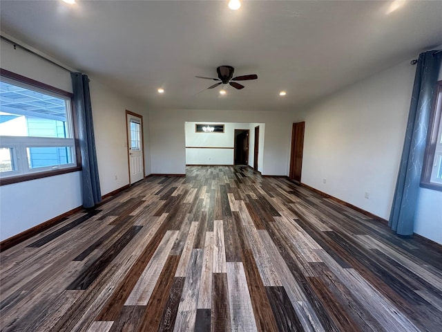 unfurnished living room with dark hardwood / wood-style floors and ceiling fan