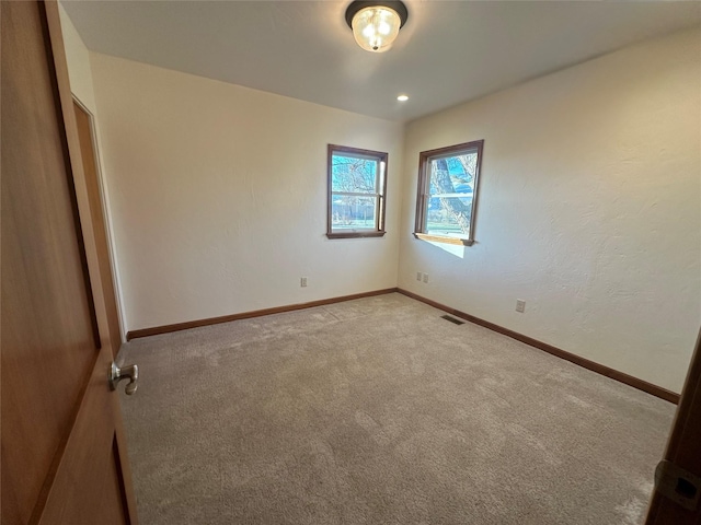 unfurnished room with light carpet