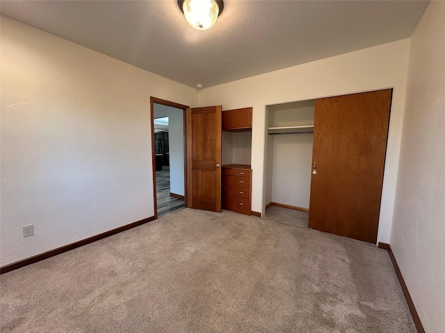 unfurnished bedroom featuring light colored carpet and a closet