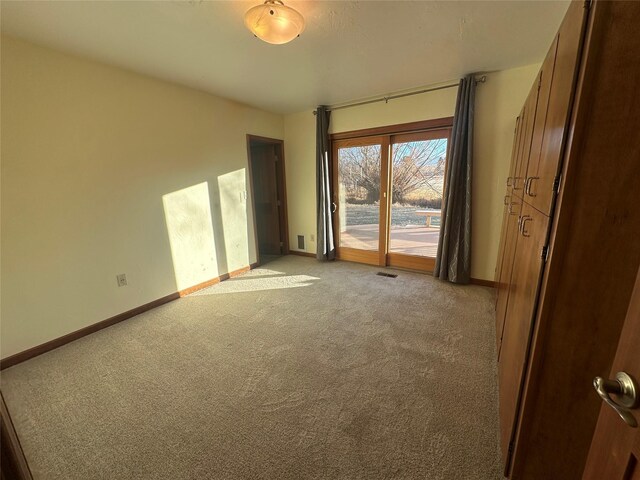 unfurnished room featuring light carpet