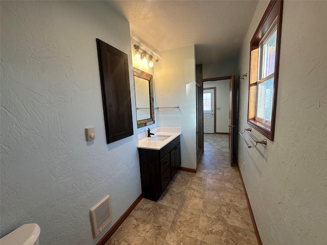 bathroom with vanity and a textured ceiling