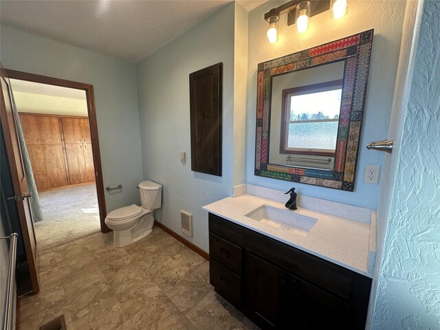 bathroom with vanity and toilet