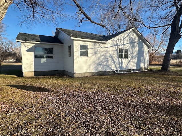 view of side of home featuring a yard