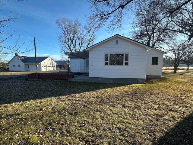 view of side of home with a yard