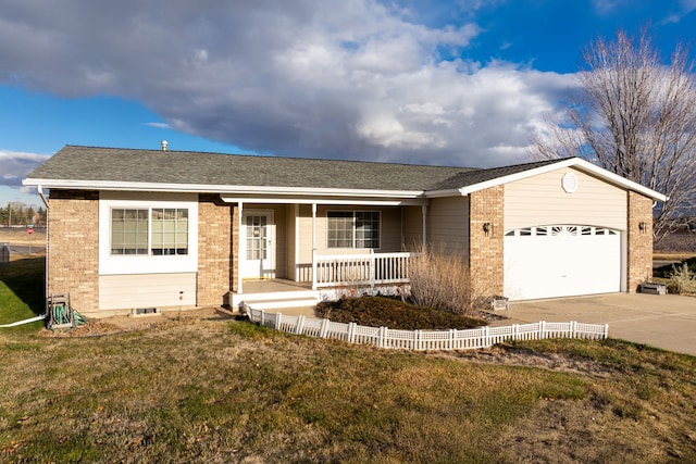 ranch-style house with covered porch, a garage, and a front lawn