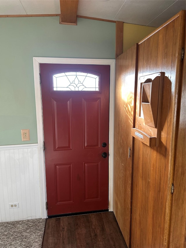 doorway to outside featuring dark hardwood / wood-style floors and wood walls