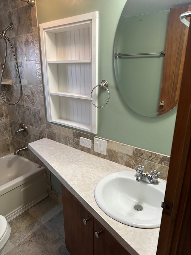 full bathroom featuring tile patterned floors, vanity, toilet, and tiled shower / bath