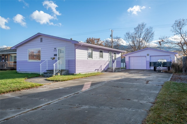 view of front of property with a garage and an outdoor structure