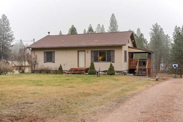 ranch-style home featuring a front yard and a deck