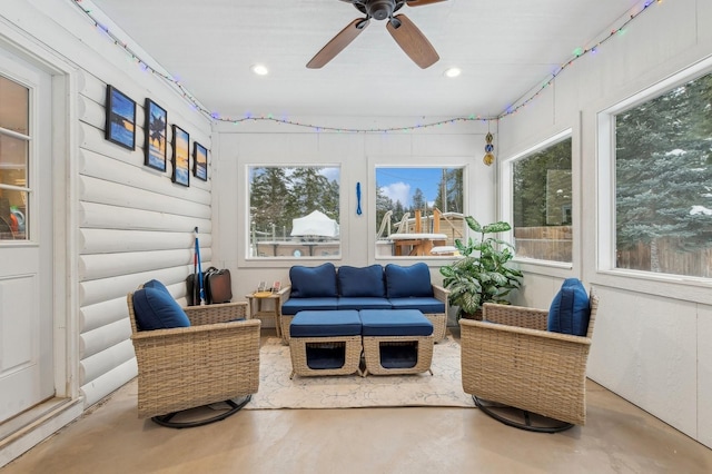 sunroom / solarium with ceiling fan and a healthy amount of sunlight