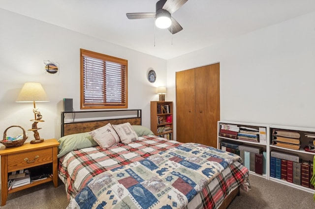 bedroom featuring dark colored carpet, a closet, and ceiling fan