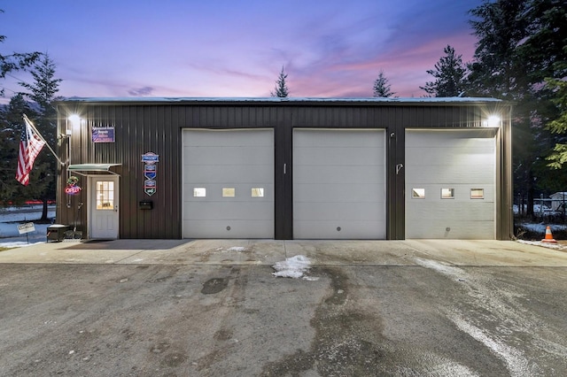 view of garage at dusk